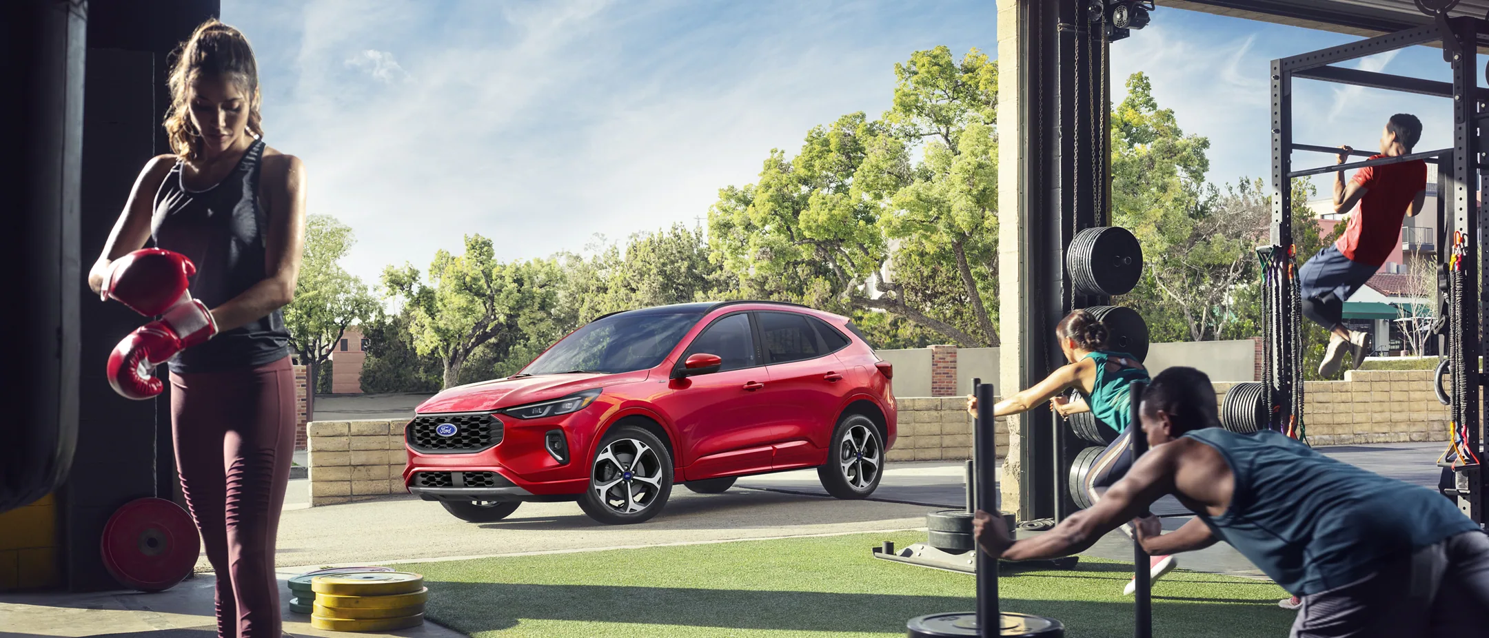 2023 Ford Escape shining in red in the background of a workout facility.