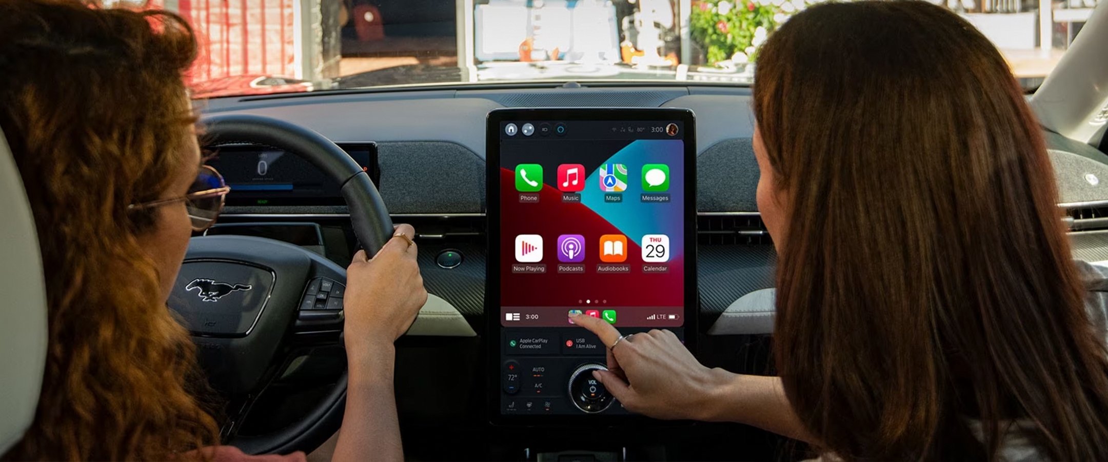 2023 Mustang Mach-E interior being showcased with Apple CarPlay.