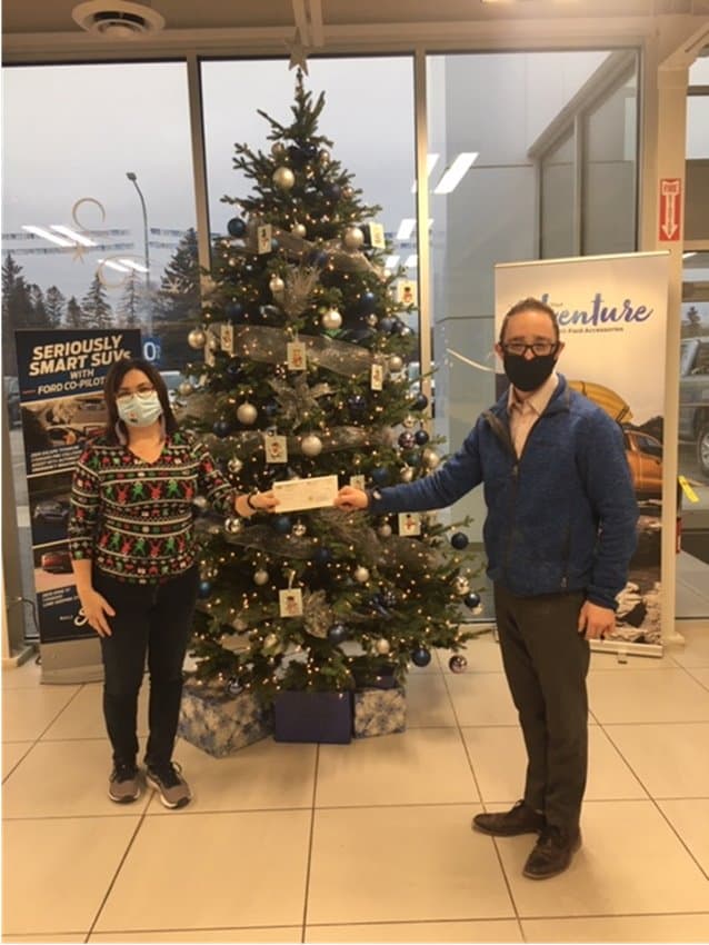 two people in front of christmas tree