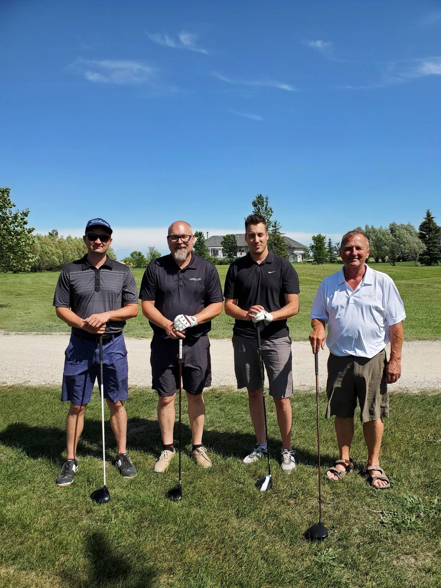 4 men with golf clubs