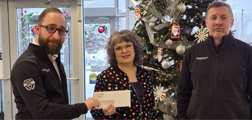 Two people in front of Christmas tree