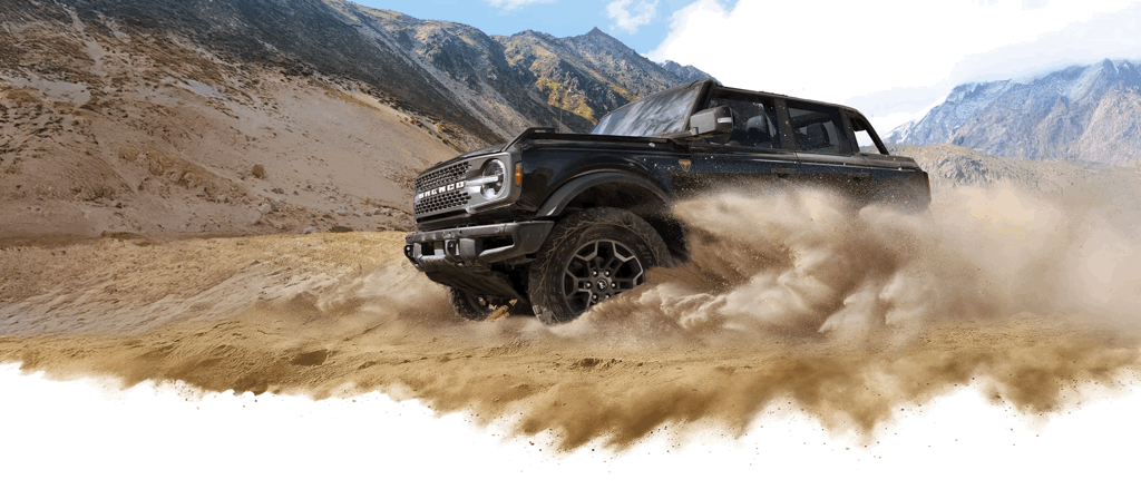 Ford Bronco 2026 noir démontrant sa puissance sur un terrain sablonneux.