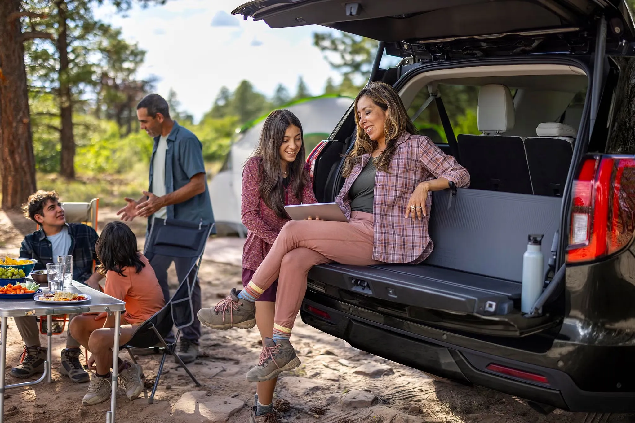 Famille réunie autour du hayon ouvert du Ford Expedition 2027 lors d’une sortie en plein air.