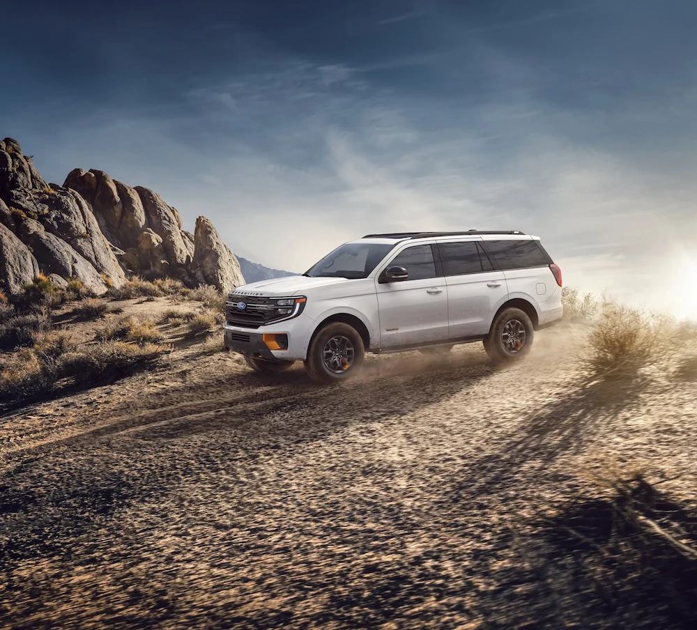 Ford Expedition 2027 blanc circulant sur un sentier rocheux, dans la section sur la consommation d’essence.