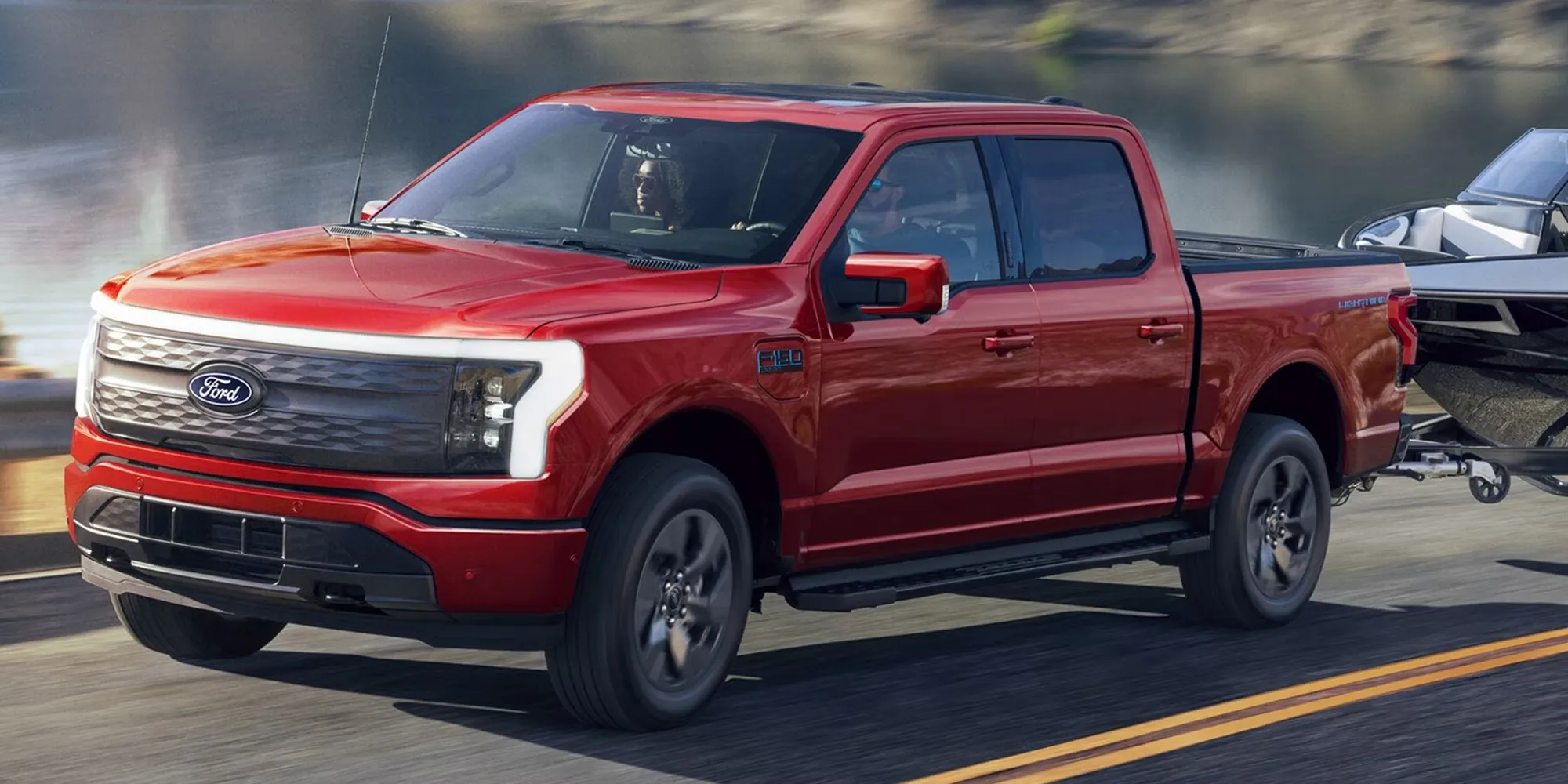 Ford F-150 Lightning rouge remorquant un bateau.