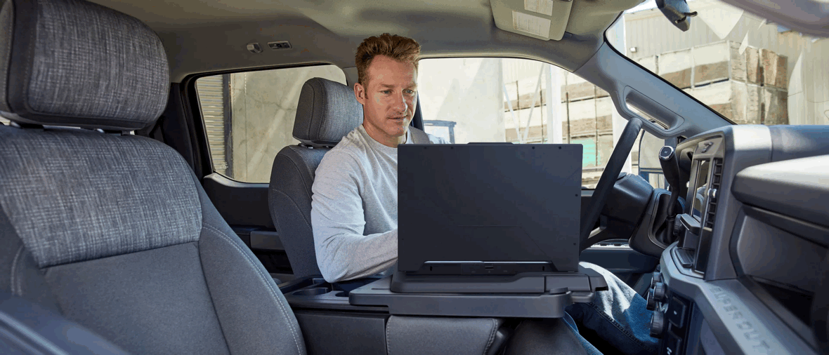 Travailleur utilisant un ordinateur portable dans l’habitacle du Ford F-250.