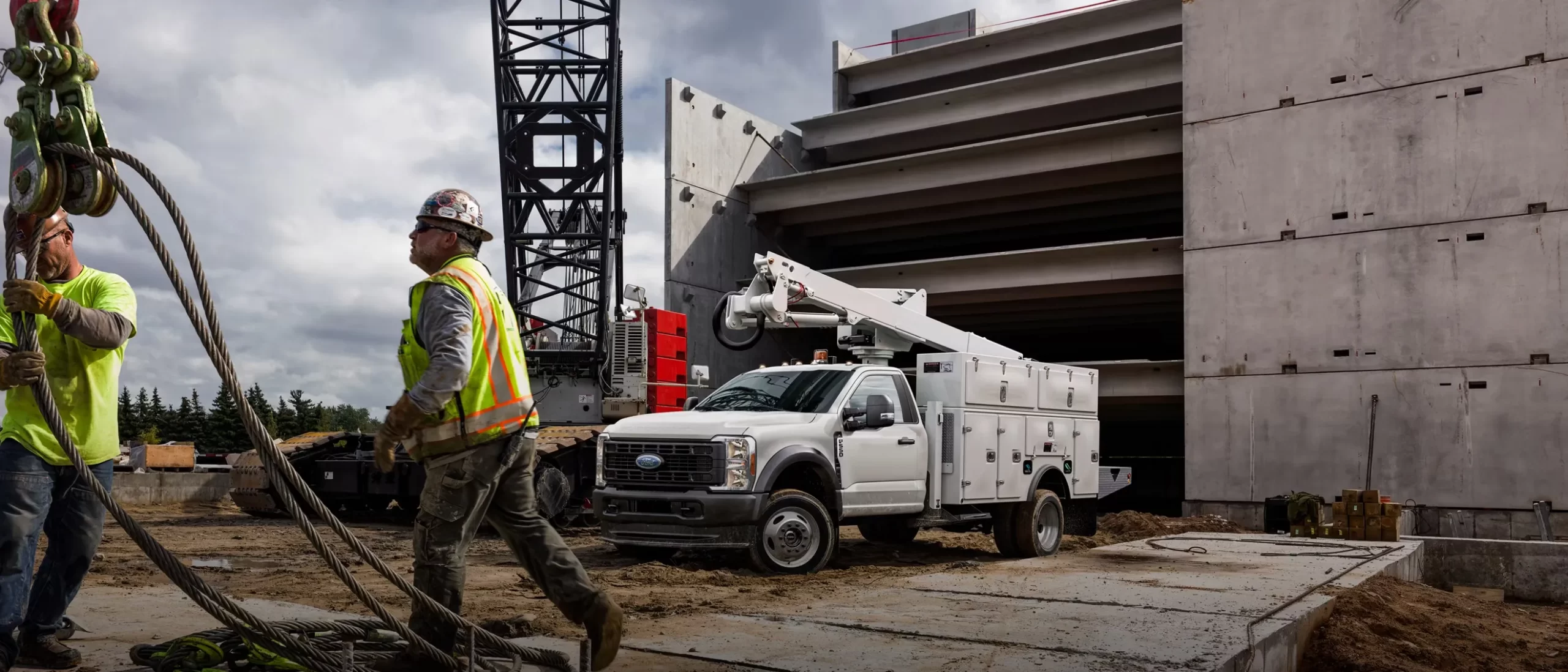 Ouvrier devant un Ford Super Duty Châssis-cabine sur un chantier.